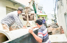 Các công nhân chuẩn bị đặt cống nâng cấp hẻm 16.